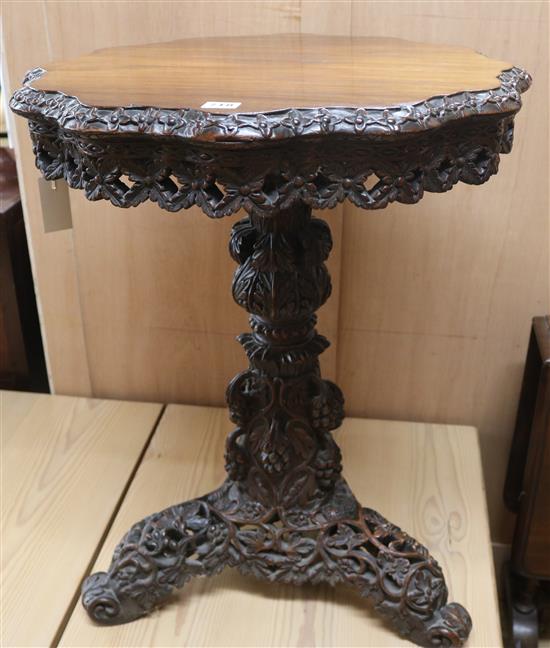 A carved hardwood tripod table, H.74cm